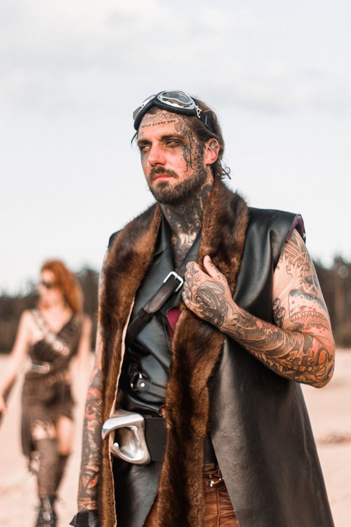Male and female models in desert-themed post-apocalyptic fashion shoot in Stockholm.